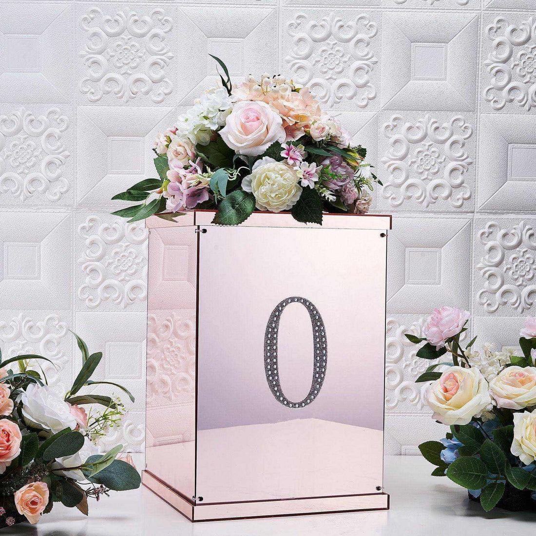Rose gold floral arrangement box with number 0 and pink flowers.