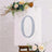 Decorative floral number "0" on a canvas with embellishments.
