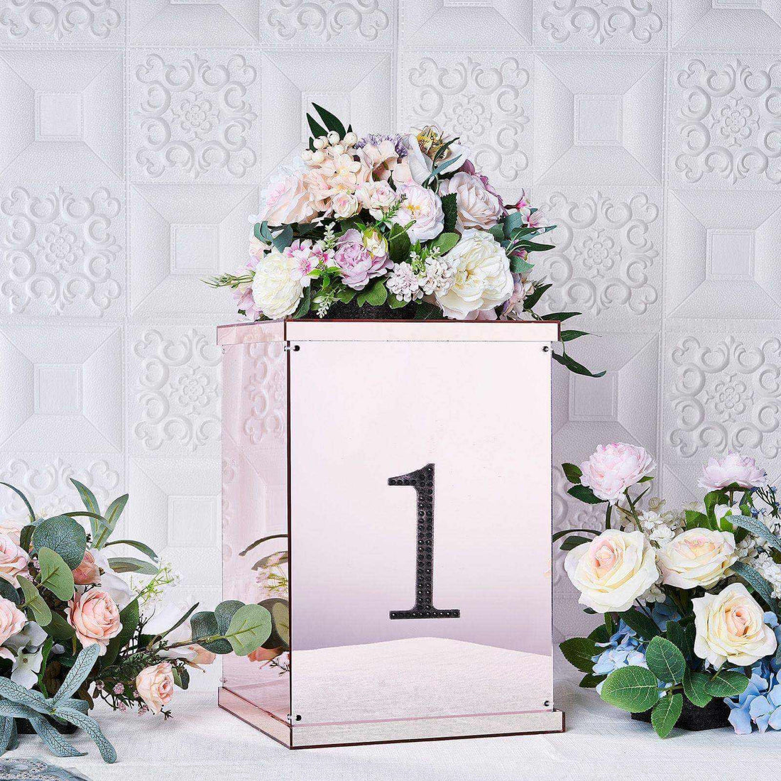 Rose gold decorative box with floral arrangement and the number 1.