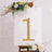 Gold rhinestone number one on a floral easel backdrop.