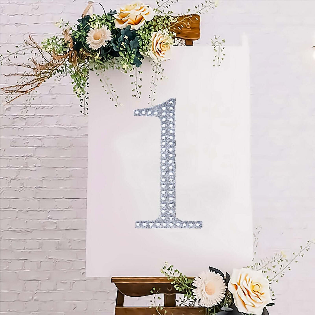 Decorative number one with floral accents on an easel.