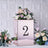 Rose gold centerpiece box with floral arrangement and number 2.
