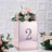 Decorative mirrored box with floral arrangement and number 2 on a textured background.