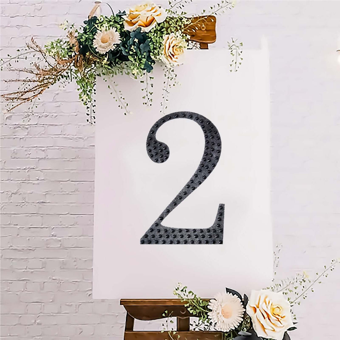 Decorative number 2 on an easel with floral accents