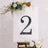 Decorative number 2 on an easel with floral accents
