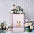 Rose gold table number holder with floral arrangement and number 3.