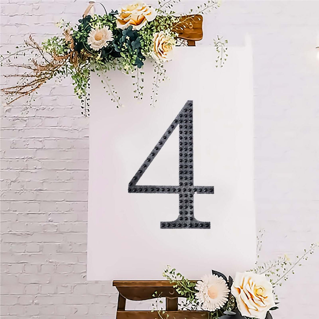 Decorative number 4 on an easel with flowers, perfect for events or celebrations.