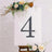 Decorative number 4 on an easel with flowers, perfect for events or celebrations.