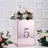 Rose gold flower box with number 5, adorned with pink and white flowers.