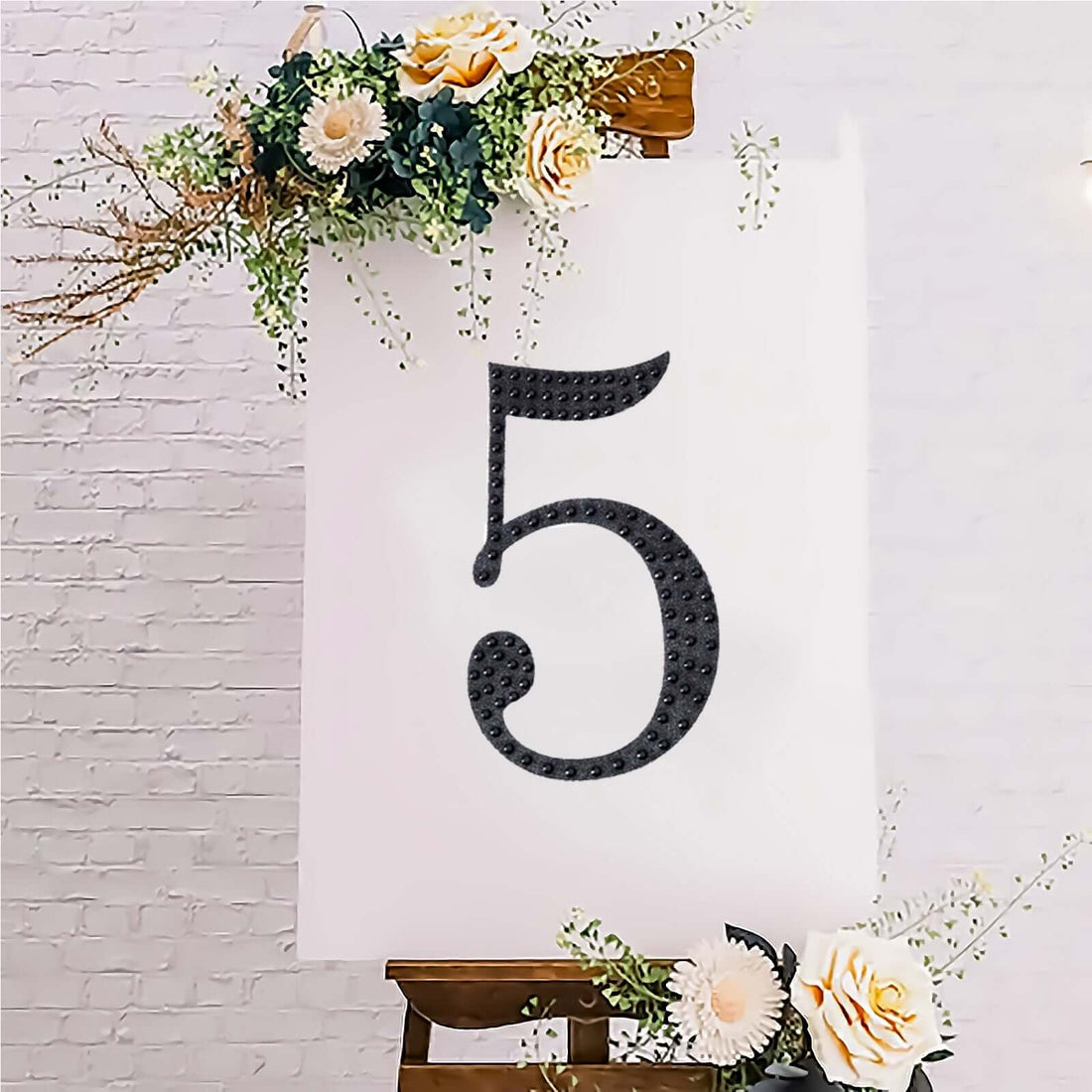 Decorative number 5 on an easel with floral accents.