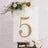 Gold rhinestone number 5 on a white backdrop with floral accents.