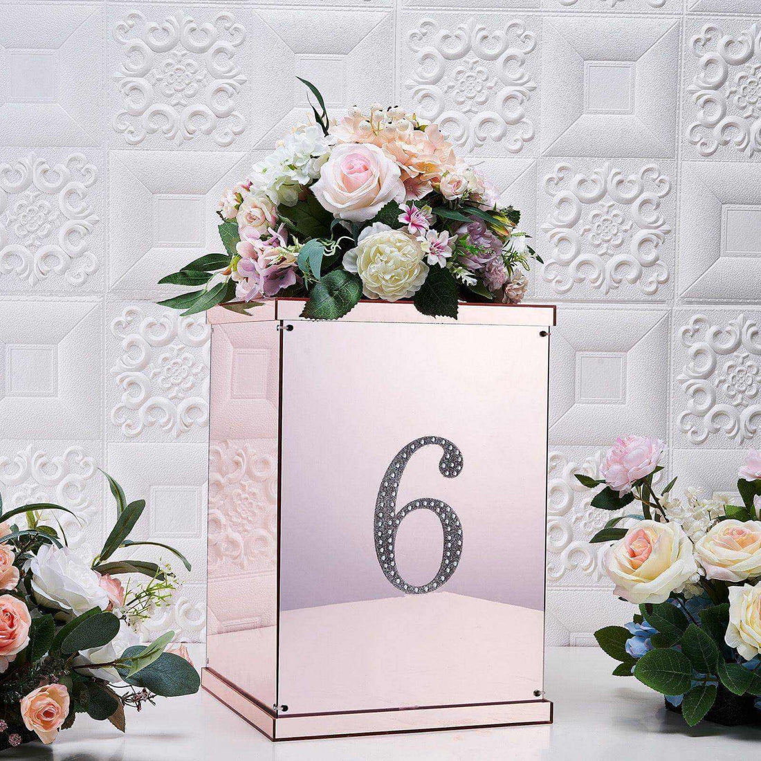 Rose gold table number holder with flowers, featuring the number six.