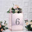 Rose gold table number holder with flowers, featuring the number six.