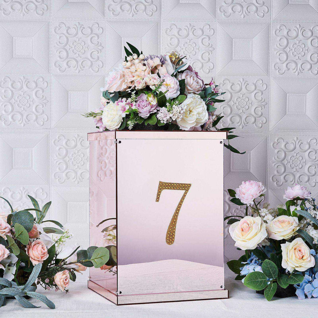 Decorative floral arrangement in a mirrored box with the number 7.