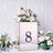 Decorative rose gold box with floral arrangement and number 8 on a textured background.