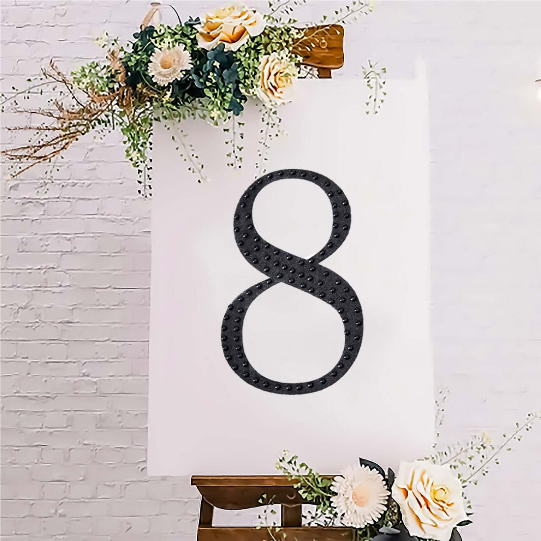 Decorative number 8 on a canvas with floral accents.
