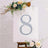 Decorative number 8 with floral accents on an easel.
