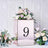 Mirrored table centerpiece with floral arrangement and number 9.