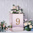 Elegant floral centerpiece with mirrored base and gold number 9.