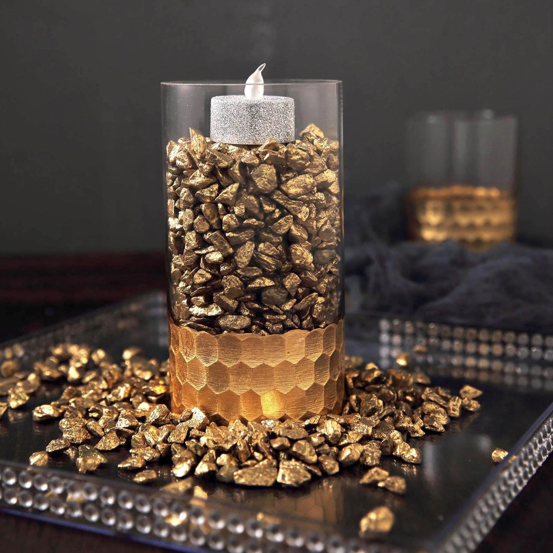 Gold rock candle holder with glittering top and textured base.