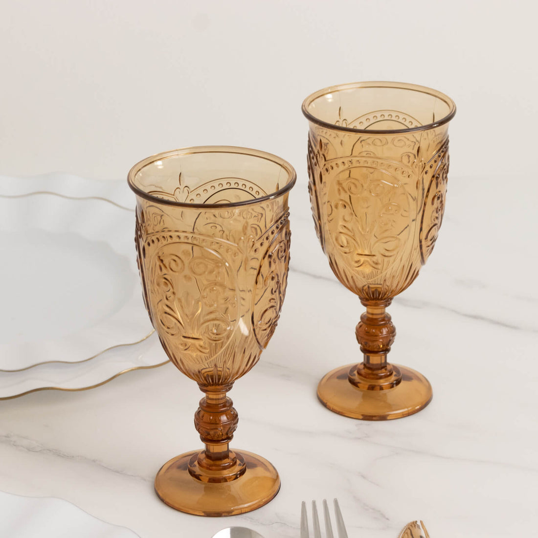 Amber decorative goblets on a table setting.