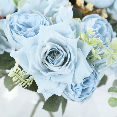 Blue rose bouquet with greenery accents.