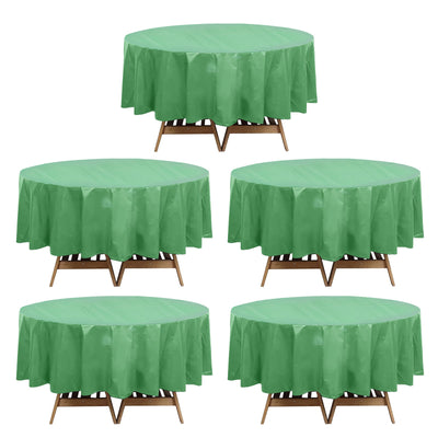 Green round table covers on wooden tables, showcasing vibrant color and design.