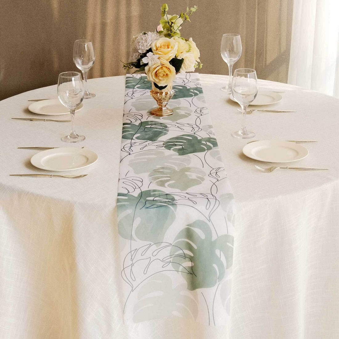 Floral table runner displayed on a beautifully set dining table.