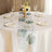 Floral table runner displayed on a beautifully set dining table.