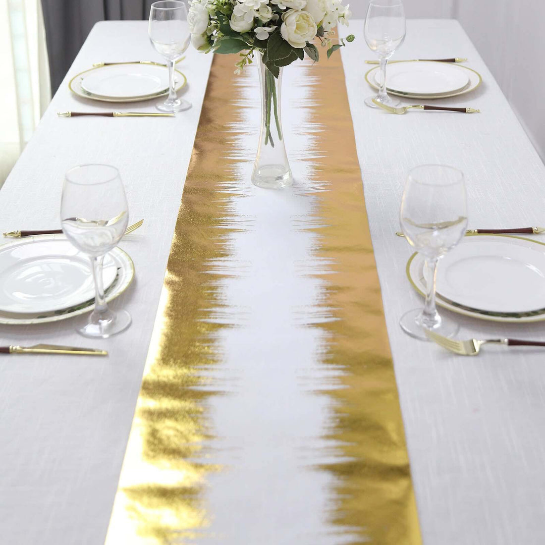 Elegant gold and white table runner on a dining table setup.