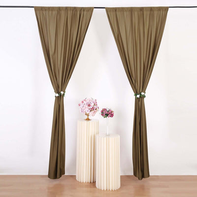 Elegant brown curtains draped with floral accents on white backdrop
