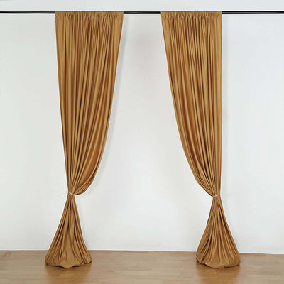Two elegant brown drape curtains hanging from a rod.