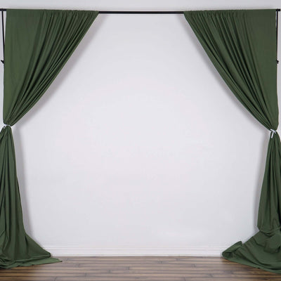 Green fabric curtains hanging in a studio setting.