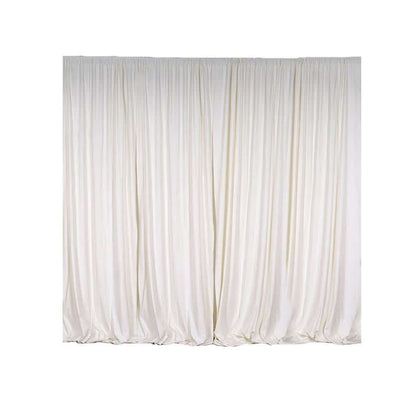 White sheer curtains draping elegantly in a studio setting.