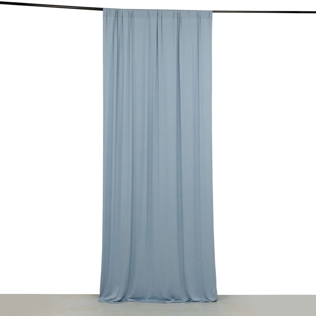 Light blue fabric curtain hanging from a black rod