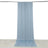 Light blue fabric drape hanging from a rod, creating soft folds on the floor.