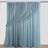 Sheer blue curtain with gathered drapes and floral tieback