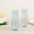 Two elegant blue champagne flutes on a wooden table.