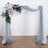Wedding arch with soft drapes and floral arrangement.