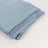 Blue fabric folded neatly on a plain background.