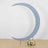 Blue crescent moon backdrop with floral arrangement at the base