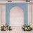 Blue arch with floral arrangements at the base, perfect for events or weddings.