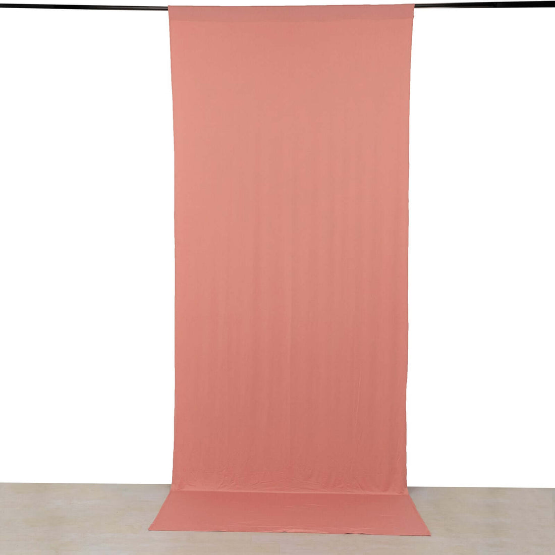 Peach fabric backdrop hanging in studio setting