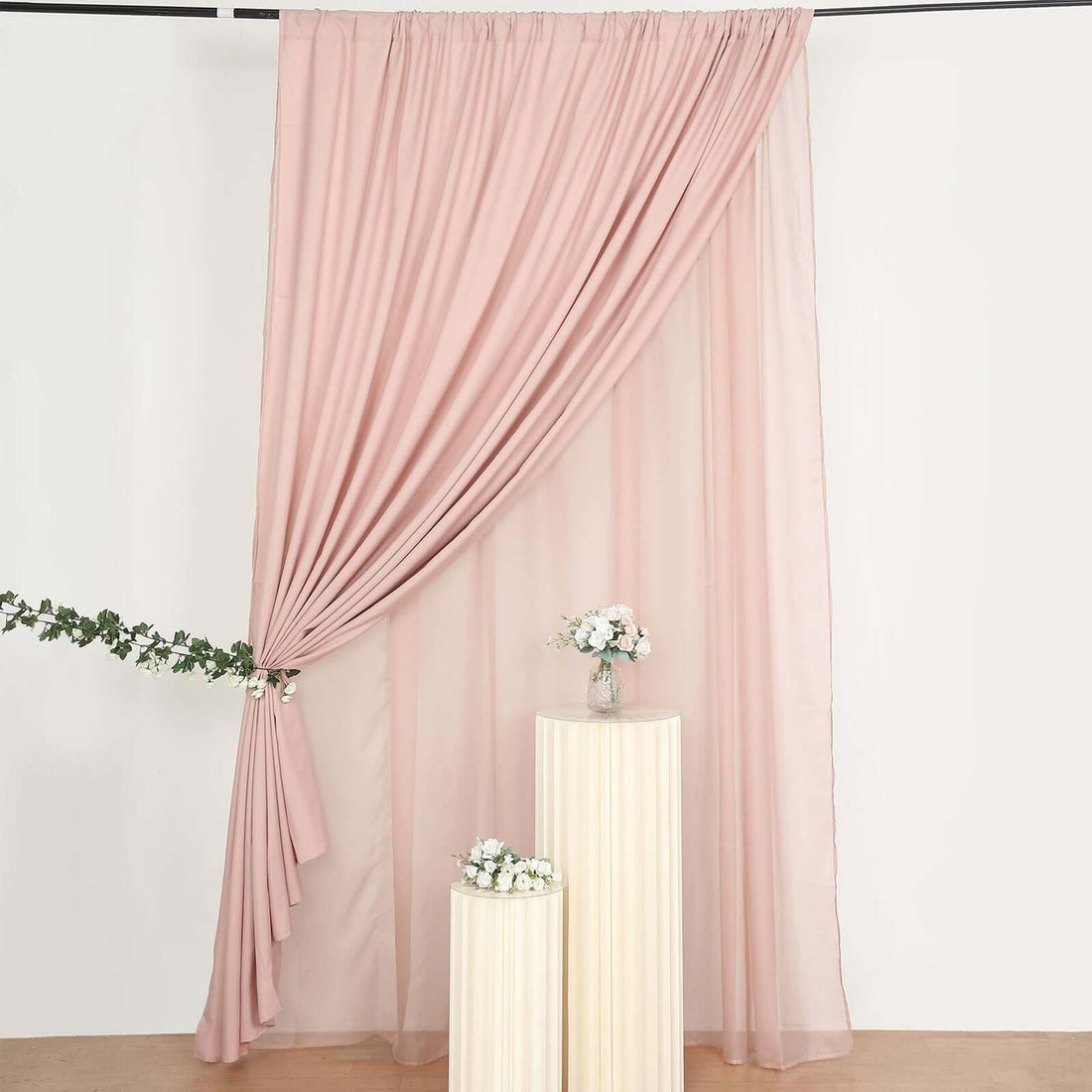 Pink sheer curtain draped elegantly with floral accents on display.