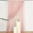 Pink sheer curtain draped elegantly with floral accents on display.