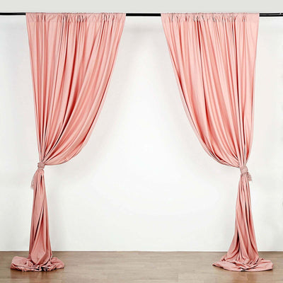 Pink drapery curtains elegantly tied back on a white background.