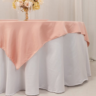 Elegant table setting with a pink tablecloth and floral centerpiece.