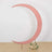 Pink crescent moon backdrop with floral arrangement at the base