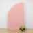 Pink backdrop with floral arrangement at the base.