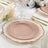 Elegant pink and gold dinnerware set on a decorated table.